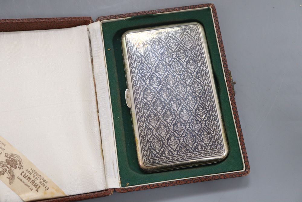 A cased mid 20th century Siamese sterling and niello cigarette case, 13.8cm, gross 5oz.